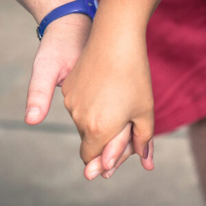 Two people holding hands