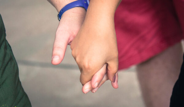 Two people holding hands