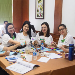 Group of women sitting at table working together