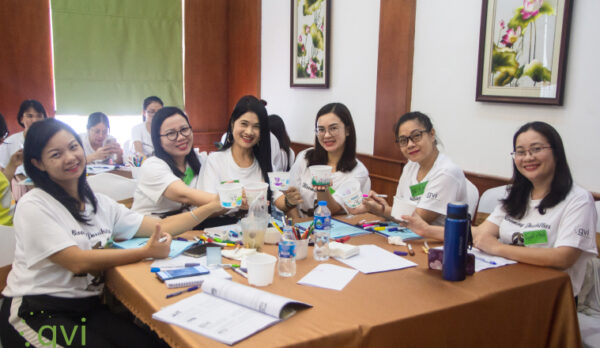 Group of women sitting at table working together