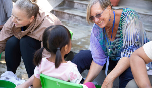 Woman helping young girl