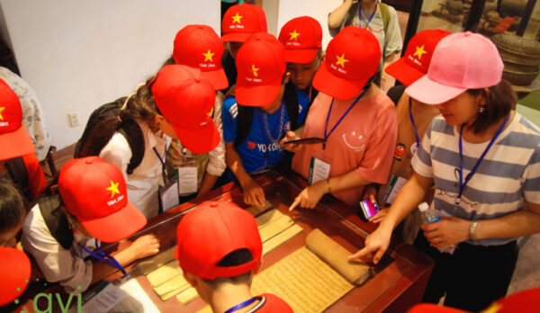 Group of young children working around table.