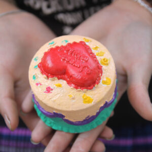 Hands holding heart shaped treat in hands