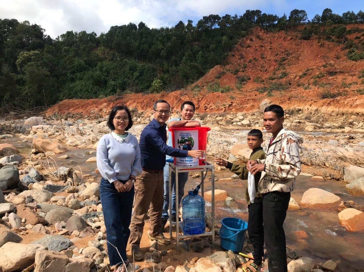 Group of people standing around water dispenser